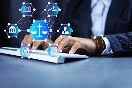 Lawyer working with computer balance scale, hammer icons, court of justice document, symbolizing the law in business organization