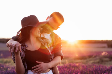 Couple in love in a lavender field at sunset