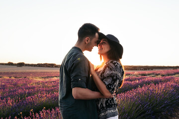 Couple in love in a lavender field at sunset