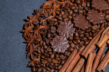 Food background. Coffee beans, cinnamon sticks, anise stars and chocolate candies top view.