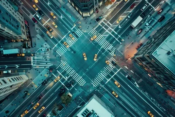 Foto op Plexiglas Aerial view of bustling city intersection with multiple lanes, traffic lights, and vivid yellow taxis © P