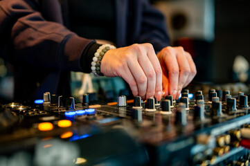 woman DJ Hands creating and regulating music on dj console mixer in concert