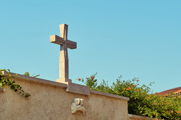 Cross on the wall by the church in the city of Piran, Slovenia