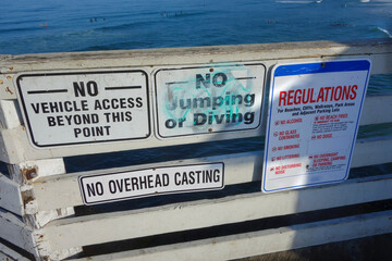 City regulations for beaches, cliffs, walkways and parking areas posted for display to public at Crystal Pier, San Diego, California