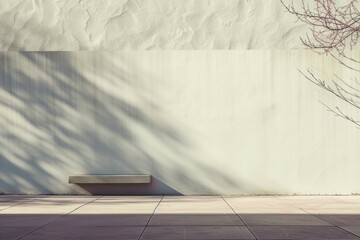 Modern minimalist concrete wall with tree shadows and bench in the urban area
