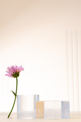 Glass podium and flower minimal scene on a beige background. Stand to show cosmetic product.