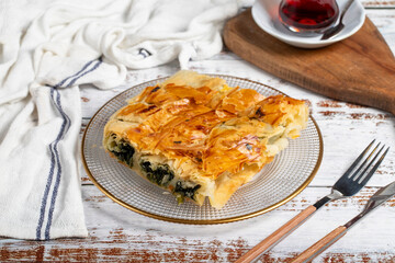 Spinach pastry. Pastry product. Spinach pie on a white background. local name ispanakli borek