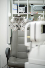 Ophthalmological cabinet with modern equipment in a medical clinic featuring an examination chair and phoropter, ready for vision testing and eye health assessments