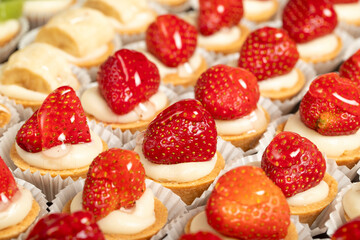 Tartlet types. Pastry product. Tartlets with kiwi, banana and strawberry on a white background. local name. Close up