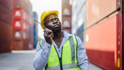 African american container male worker or dock foreman standing at warehouse logistic in Cargo...