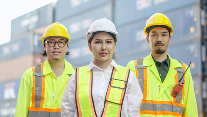 Portrait of group male and female container worker or dock foreman confident and smiling standing at warehouse logistic in Cargo freight ship for import export in harbor, happy employees arms crossed