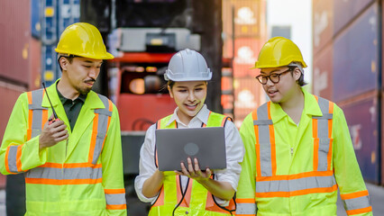 Front of group professional dock worker and engineering people walking and taking with their supervisor while record data online with digital connection tablet, background of crane and layer of tank