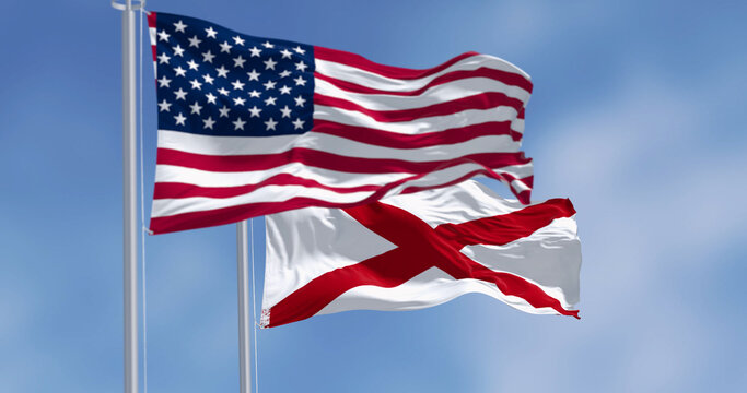 Alabama and the United States flags waving on a sunny day