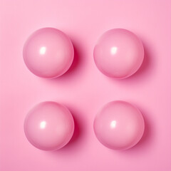 photo of 4 pink gumballs, pattern, overhead view, backdrop solid pink background