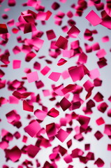 Metallic Pink Confetti Spread on a Neutral Background