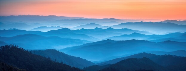 Warm Sunset Glow Over Misty Mountain Layers: A Gradient of Blues to Oranges Across Softened Ridges