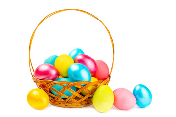 Naklejka premium Easter basket filled with colorful eggs isolated on white background. Easter celebration concept. Colorful easter handmade decorated Easter eggs.