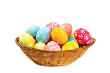 Easter basket filled with colorful eggs isolated on white background. Easter celebration concept. Colorful easter handmade decorated Easter eggs.