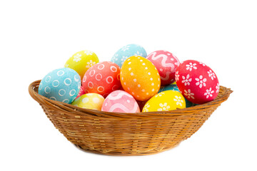 Easter basket filled with colorful eggs isolated on white background. Easter celebration concept. Colorful easter handmade decorated Easter eggs.