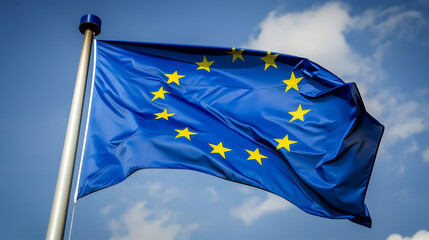 Waving European Union Flag Against Blue Sky Symbolizing Political Integration and Unity, EU Symbol.