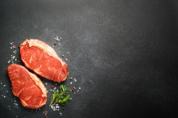 Beef steak. Raw beef meat at black.