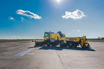 Snow removal vehicles in the airport. Snow plow trucks. Airport maintaining machinery. Training snow plow operators before winter.