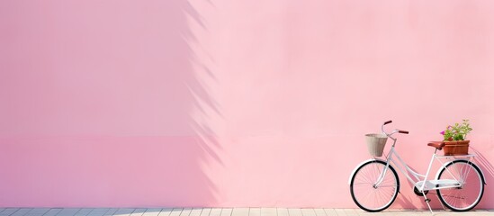 Vintage White Bicycle Leaning Against a Charming Pink Wall in Urban Setting