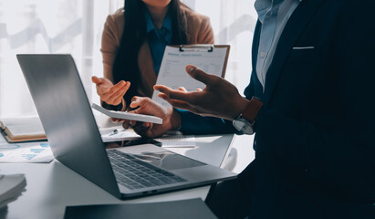 Business team working with new startup project plan and discussion information for financial strategy with laptop and digital tablet in a modern business lounge.