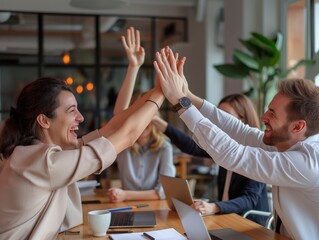 A marketing agency team celebrating a successful campaign launch with high-fives and smiles