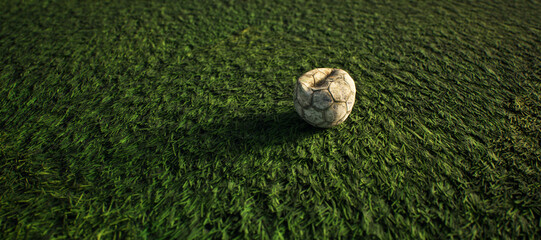 Worn old football on artificial grass. Lit by sunlight. - 745930919