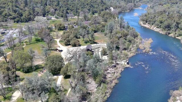 North Fork of the American River at the gold discovery site in Coloma, California showing the rapids and the Sutter Bridge. 