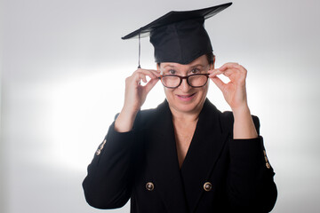 Mature woman with glasses and graduation cap