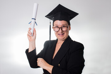 Mature woman with graduation cap showing her certificate