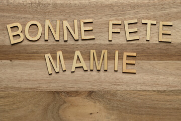 Happy Grandma's Day with wooden letters on textured background