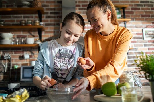 Mother and daughter baking together at home