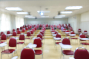 Blurred abstract background of examination room with undergraduate students inside. Blurred view of...
