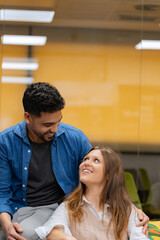 A man and woman share a tender look, connecting warmly in a cozy, indoor setting. 