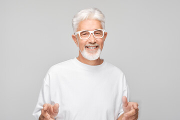 Portrait gray-haired man smiling joyfully with happy face isolated on white studio background,...