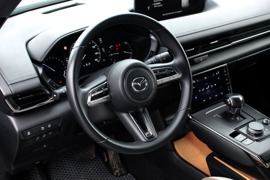 Vinnytsia, Ukraine; February 24, 2024. Electric SUV Mazda MX-30 steering wheel. Close up steering wheel. Mazda MX-30 interior. Mazda MX-30 dashboard.