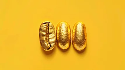 Foto op Plexiglas Three golden coffee beans on a yellow background, symbolizing luxury and high quality in coffee production © Sohaib q