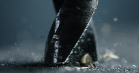 Super slow motion macro of artisan carpenter is working on wood surface with hammer drill machine bit with flying wood chipping shaving pieces and sawdust on workbench in workshop at 1000 fps. - Powered by Adobe