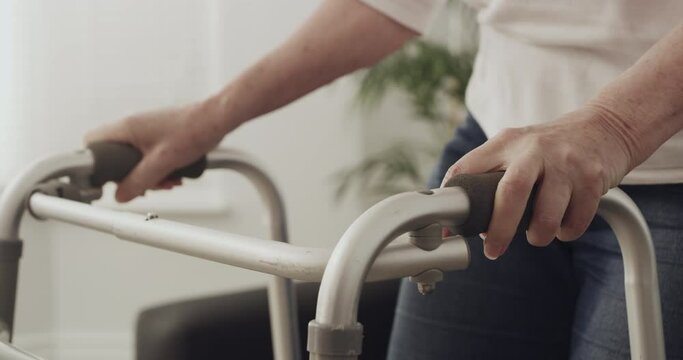 Senior woman, support or walker for person with disability, chiropractor care or spine problem in rehabilitation. Mature lady, osteoporosis or walking aid in recovery by sofa or injury in living room