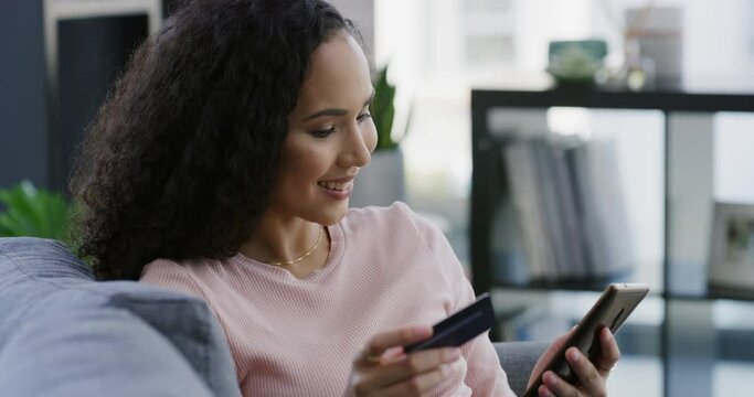 Woman, credit card and phone on sofa for online shopping, e commerce and payment at home.. Young person relax on couch with mobile for internet banking, website subscription or registration for loan