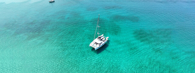 Aerial drone ultra wide photo of beautiful catamaran sail boat sailing in tropical exotic bay with...