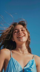 Young Woman Smiling Her Hair is Blown by the Wind - Blue Background Seeing The Upper Body when wearing Blue Clothes in Summer and The Sun is Bright Wallpaper created with Generative AI Technology