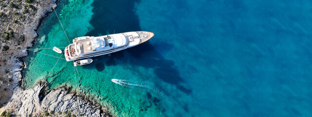 Aerial drone ultra wide top down photo with copy space of luxury yacht anchored in tropical exotic...