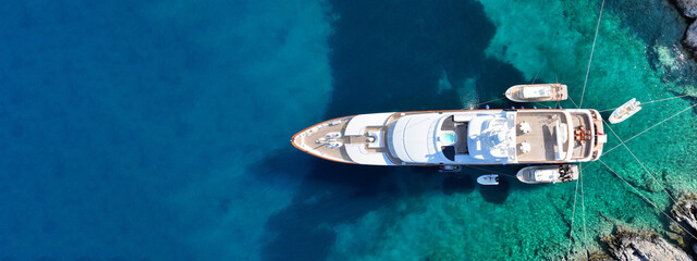 Aerial drone ultra wide top down photo with copy space of luxury yacht anchored in tropical exotic...