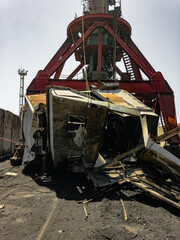 Fototapeta premium An emergency situation. Disaster. The fall of the gantry crane. A fallen object with a defocused crane, a construction site. An example of a security breach. A heavy crane in the foreground. 