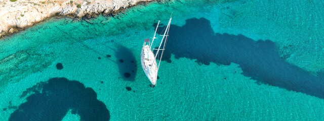 Aerial drone ultra wide photo of sail boat anchored in tropical exotic turquoise calm waters...