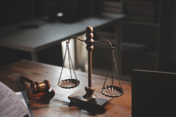 image of judge's hammer, scales lady of justice, law book, laptop computer and contract documents...
